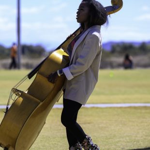 Joelle Tambe-Ebot heads to the stage with her upright bass.