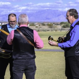 The Country Gentlemen Show tune up backgrounded by the Rincon Mountains.